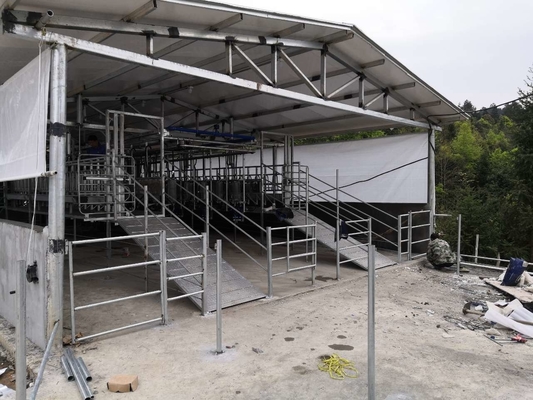 Sala di mungitura della spina di pesce delle pecore dell'attrezzatura di azienda lattiera con la bottiglia di misurazione di vetro